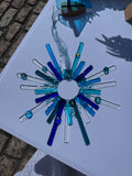Handmade blue starburst fused glass suncatcher with cobalt, teal and clear glass rods